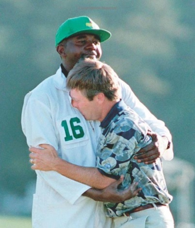 1995 - Ben Crenshaw wins his second Masters tournament, having served as a pall bearer at the funeral of his beloved mentor and longtime teacher, Harvey Penick the previous Tuesday. Here he is embraced after the emotional win by his caddie, Carl Jackson. 
